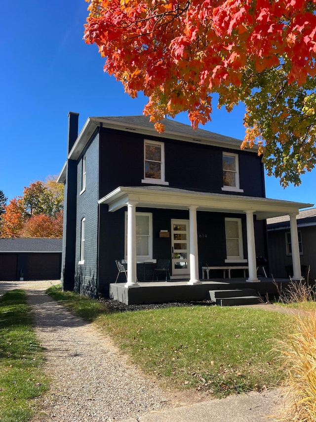 front facade featuring a porch and a front lawn