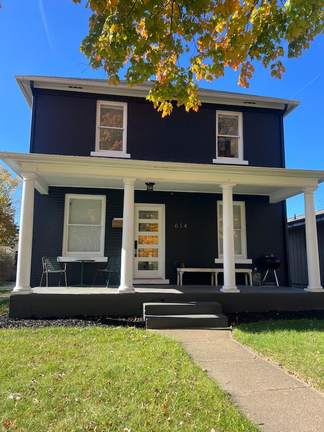 view of front of property featuring a front lawn and covered porch