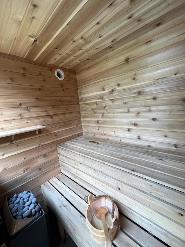 view of sauna / steam room with wood ceiling and wood walls