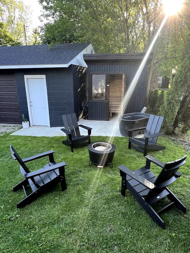 exterior space with a lawn and a fire pit