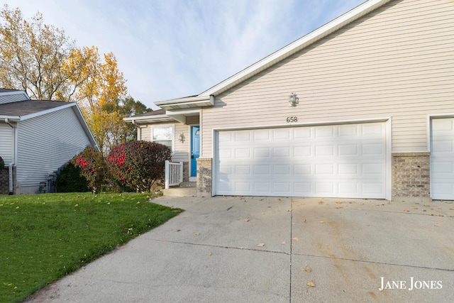 view of front of home with a front yard and a garage