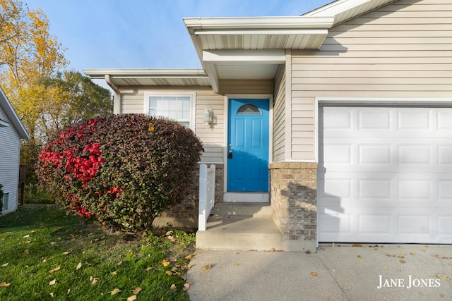 view of exterior entry featuring a garage