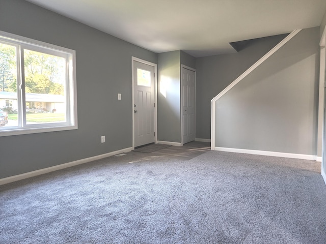 foyer entrance featuring carpet