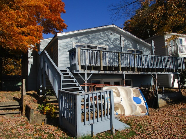 back of property with a wooden deck