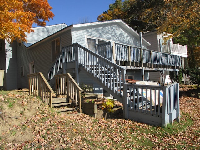 back of house with a deck