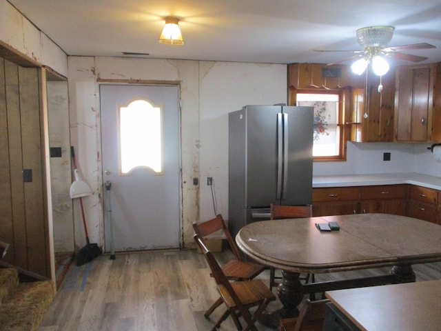 kitchen featuring light hardwood / wood-style flooring, stainless steel refrigerator, and ceiling fan