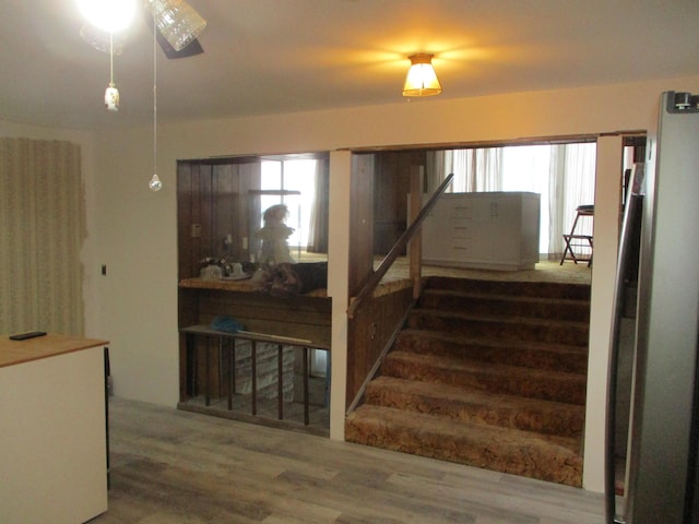 staircase with hardwood / wood-style flooring and ceiling fan