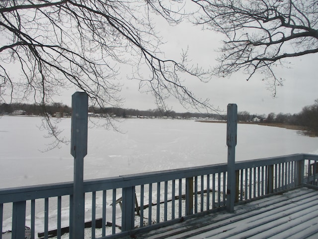 snow covered deck with a water view