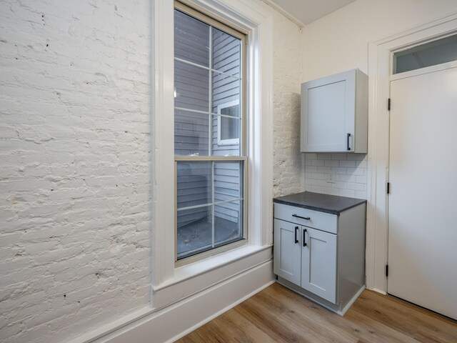 interior space featuring decorative backsplash and light hardwood / wood-style floors