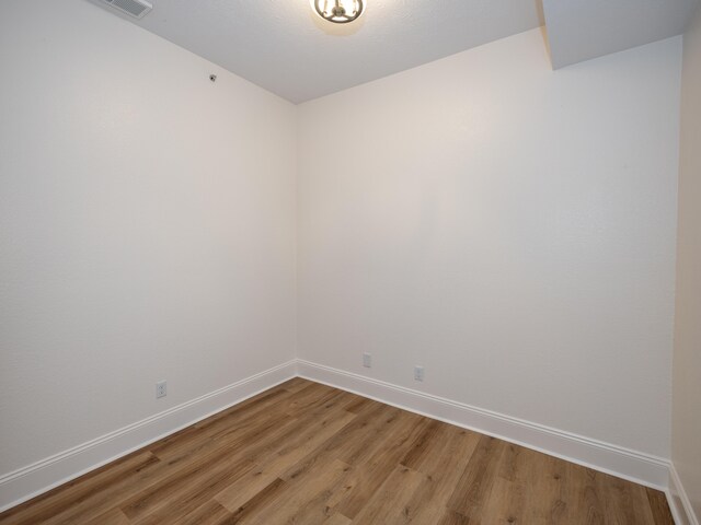 empty room with hardwood / wood-style flooring