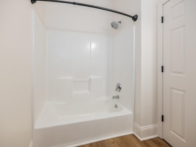 bathroom featuring hardwood / wood-style flooring and shower / bathtub combination