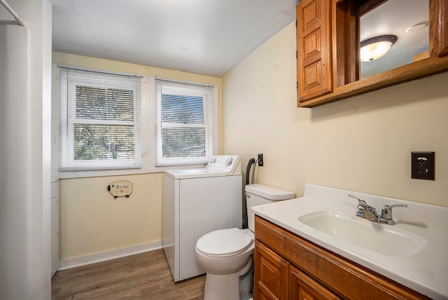 bathroom featuring washer / dryer, hardwood / wood-style flooring, toilet, and vanity