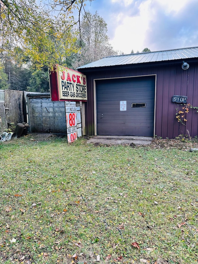 garage featuring a lawn