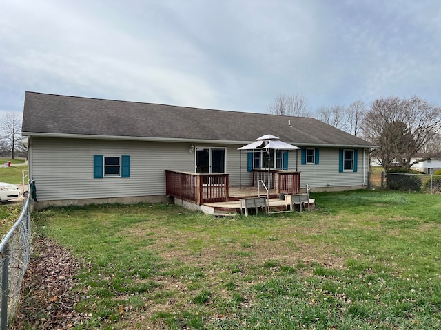 back of house featuring a deck and a yard