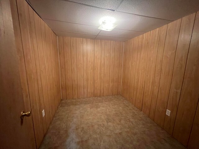 unfurnished room with wooden walls