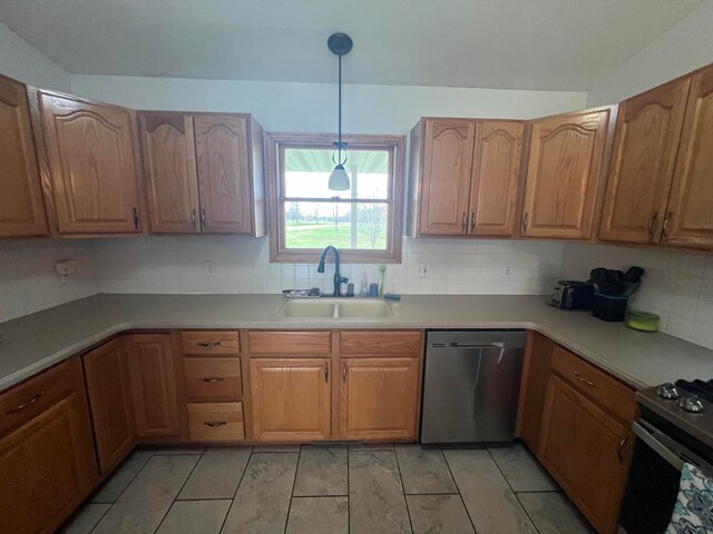 kitchen featuring dishwasher, hanging light fixtures, sink, and backsplash