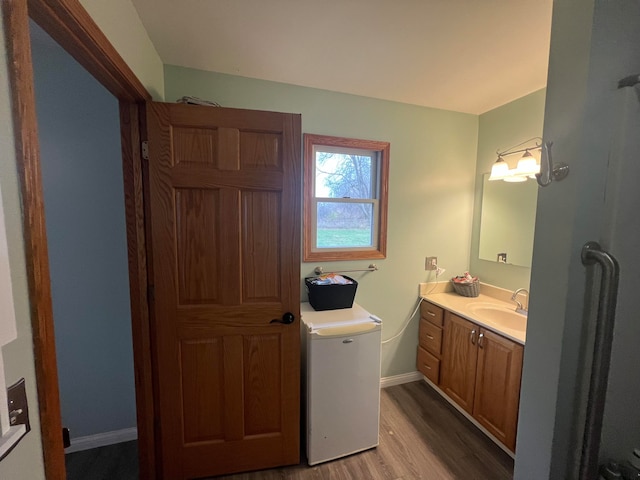 bathroom featuring vanity, hardwood / wood-style flooring, and toilet