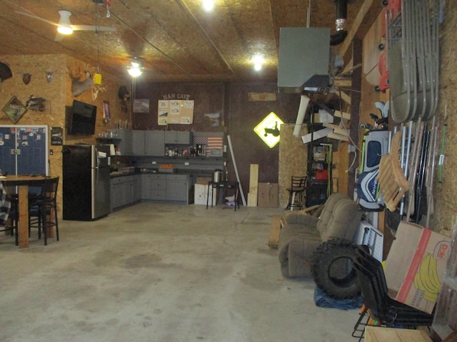 garage with a workshop area and fridge