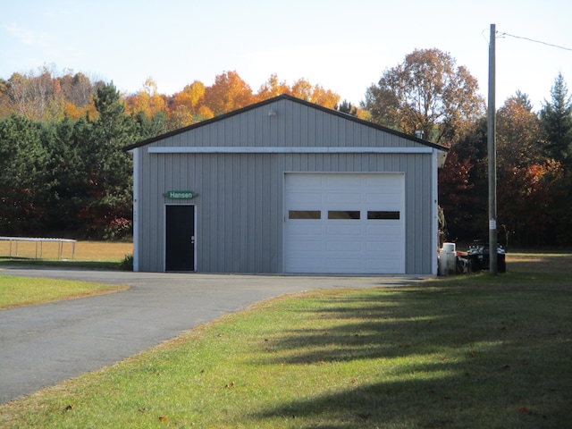 garage featuring a lawn