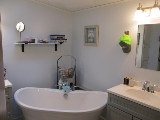 bathroom with a tub, crown molding, and vanity