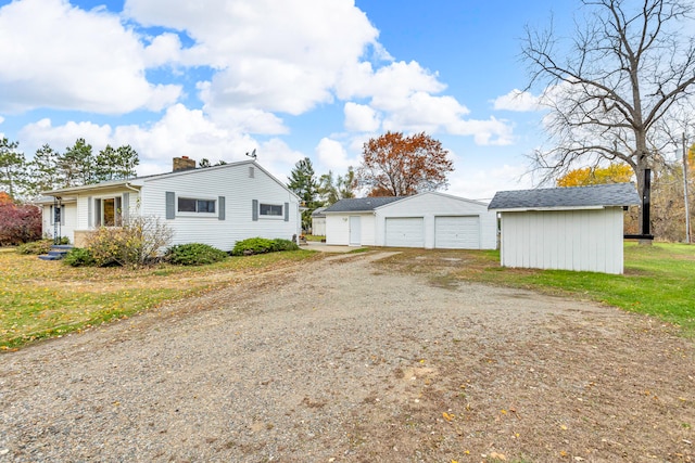 view of property exterior with an outdoor structure and a garage