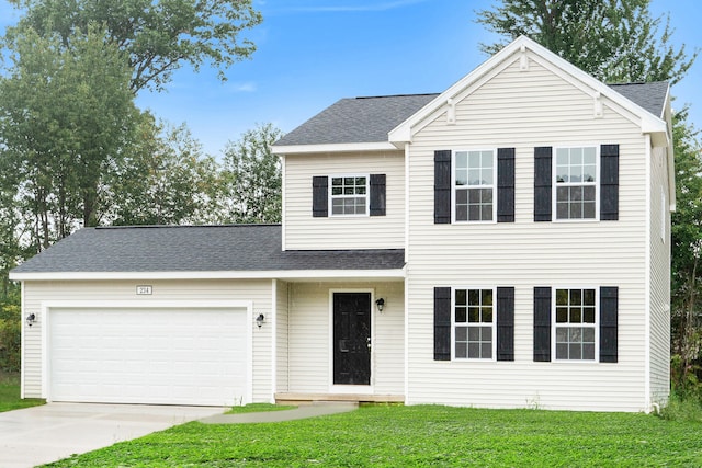 view of property with a front yard and a garage