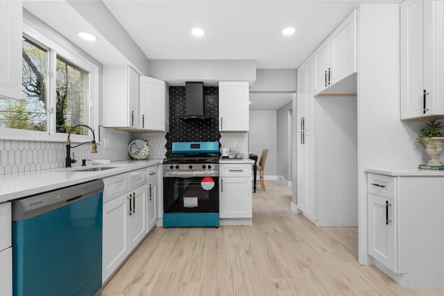 kitchen featuring wall chimney range hood, appliances with stainless steel finishes, and white cabinetry