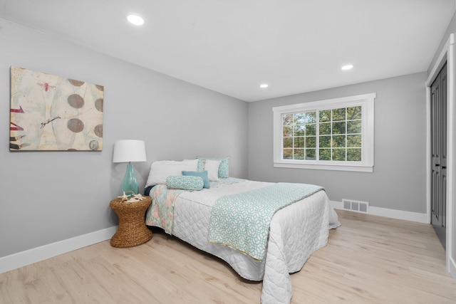 bedroom featuring light hardwood / wood-style flooring and a closet