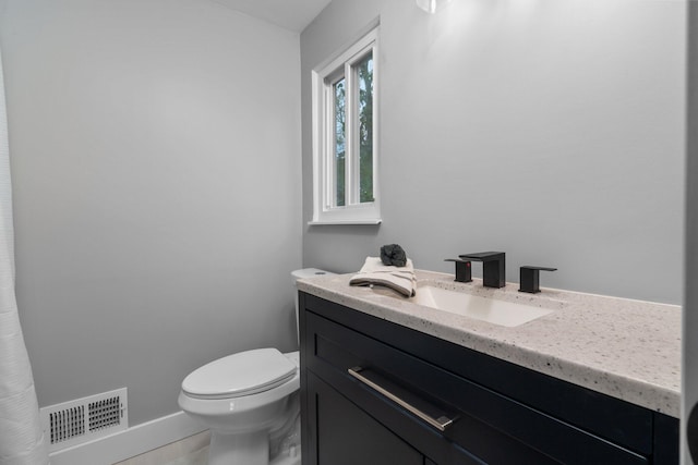 bathroom with vanity, toilet, and tile patterned flooring