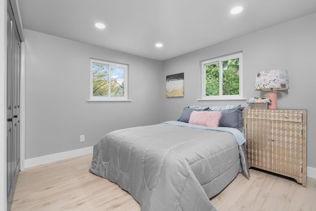 bedroom featuring multiple windows and light wood-type flooring