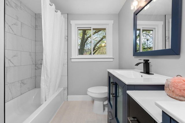 full bathroom featuring vanity, a healthy amount of sunlight, and toilet