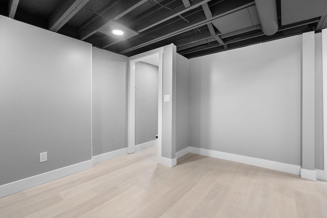 basement with light hardwood / wood-style floors