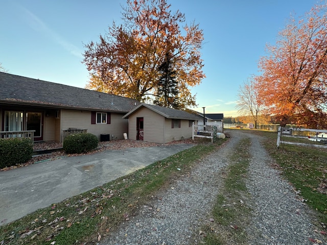 property exterior at dusk featuring central AC unit