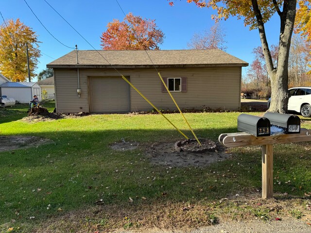 view of side of home with a lawn and a garage