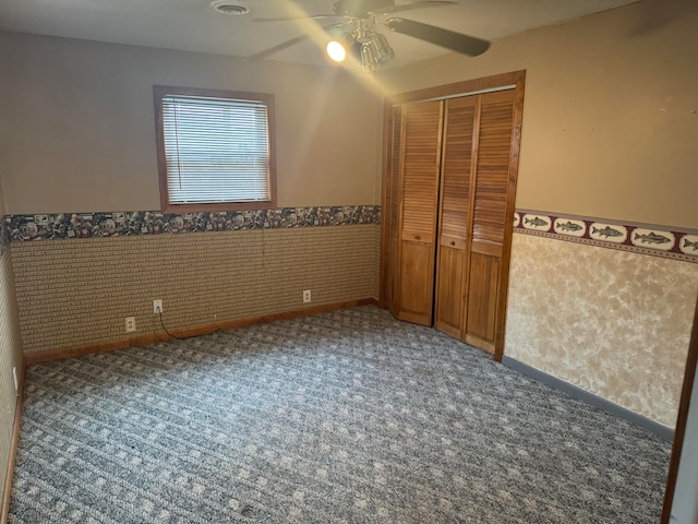 unfurnished bedroom with a closet, carpet floors, and ceiling fan