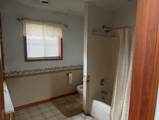 full bathroom with vanity, shower / tub combo, and toilet