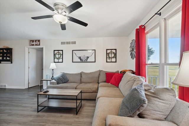 living room featuring hardwood / wood-style floors and ceiling fan