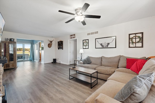 living room with hardwood / wood-style floors and ceiling fan