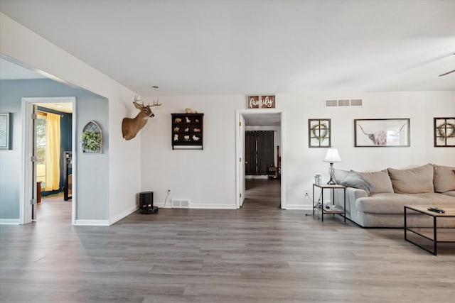 living room featuring hardwood / wood-style floors and ceiling fan