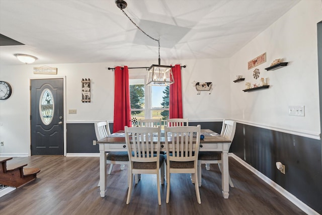 dining area with a notable chandelier and wood-type flooring