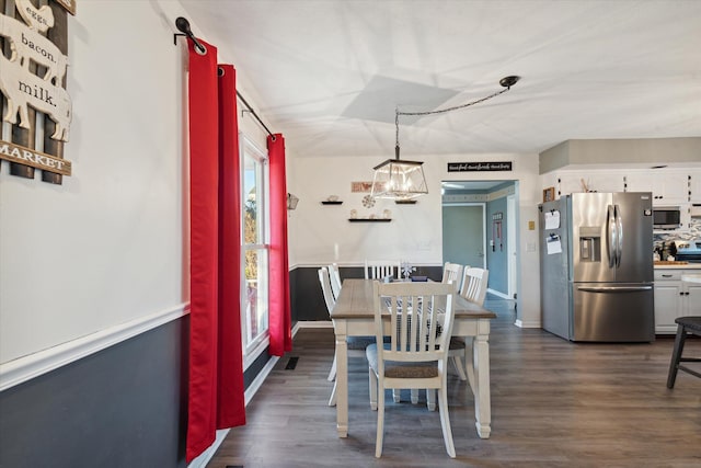 dining space featuring dark hardwood / wood-style flooring