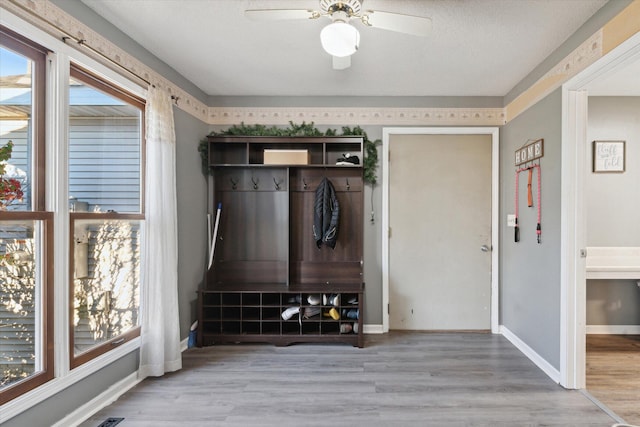 mudroom with a textured ceiling, light wood-type flooring, and ceiling fan