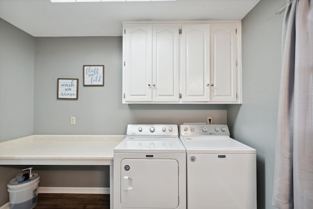 clothes washing area with cabinets, wood-type flooring, and washing machine and dryer