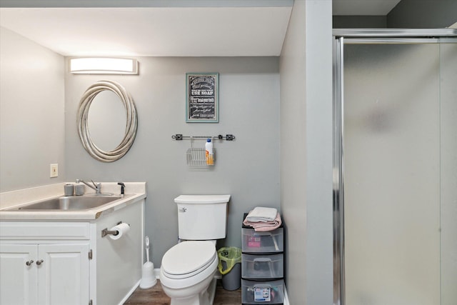 bathroom featuring vanity, toilet, and walk in shower