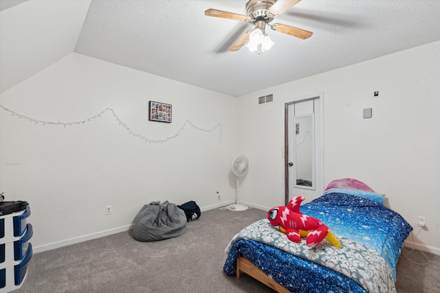 bedroom with lofted ceiling, carpet, a textured ceiling, and ceiling fan