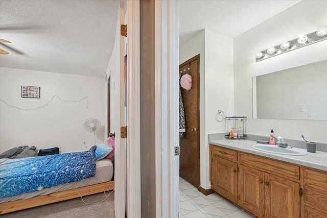 bathroom featuring vanity, a textured ceiling, tile patterned floors, and ceiling fan