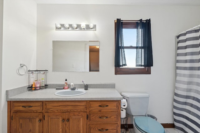 bathroom with toilet, vanity, and a shower with shower curtain