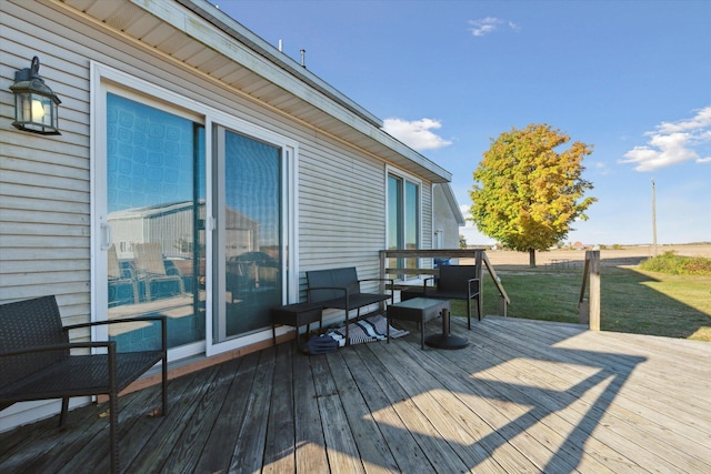 wooden deck featuring a lawn