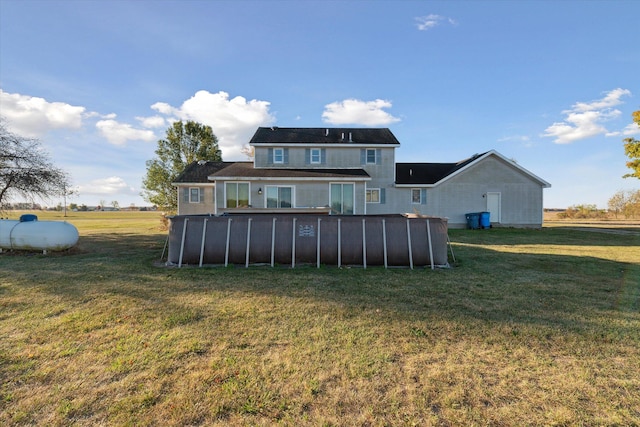 rear view of house with a yard