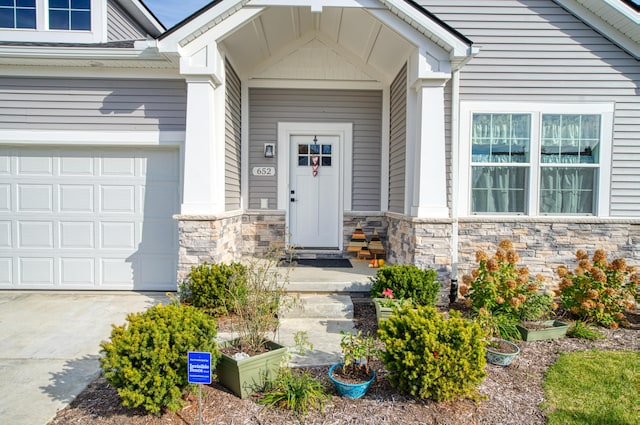 view of exterior entry with a garage